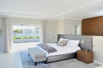 a bedroom with a bed and a large window at Grand Blue D in Cape Town