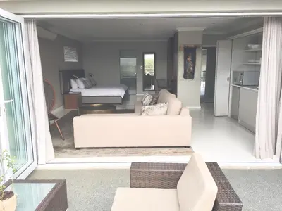 a living room with a white couch in a room at Grand Blue D in Cape Town