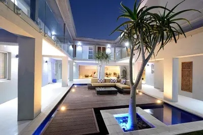 a living room with a palm tree in the middle at Grand Blue D in Cape Town