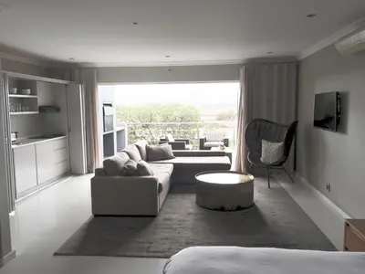 a living room with a couch and a table at Grand Blue D in Cape Town