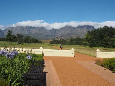 a park with a bench and mountains in the background at Swallow's Nest in Somerset West