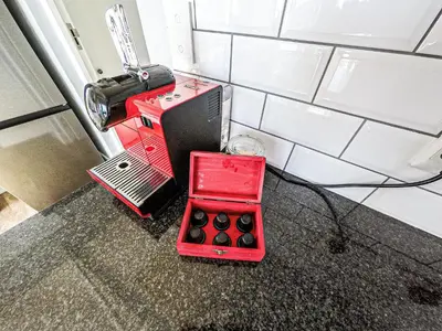a red machine sitting on the floor in a room at Kallistes Misty Shores Cottage in Bettyʼs Bay