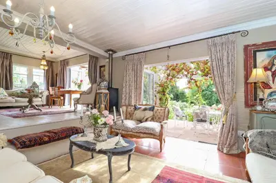 a living room with a couch and a table at Three Oaks in Durbanville