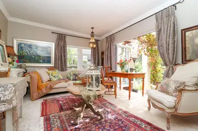 a living room with a couch and a table at Three Oaks in Durbanville