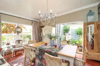 a dining room with a table and chairs at Three Oaks in Durbanville