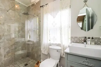 a bathroom with a toilet and a shower and a sink at Three Oaks in Durbanville