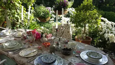 a table with plates and dishes on it in a garden at Three Oaks in Durbanville