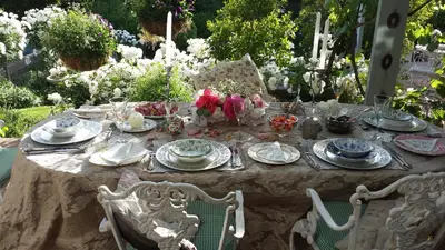 a table with plates and glasses and flowers on it at Three Oaks in Durbanville