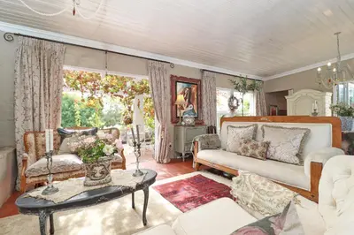 a living room with a couch and a table at Three Oaks in Durbanville