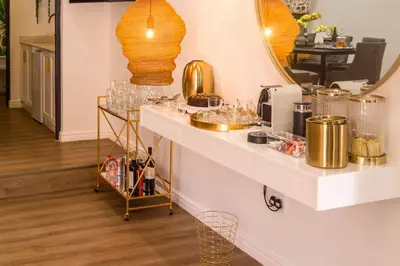 a counter with glasses on it in a room at The Ivy Apartments Franschhoek in Franschhoek