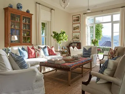 a living room with white couches and a coffee table at La Cotte House in Franschhoek