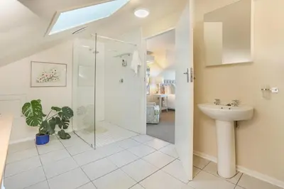 a bathroom with a shower and a sink at Elgin Country Lodge in Elgin