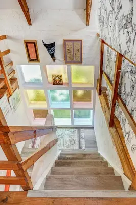 a staircase in a house with colorful windows at Festina Lente in Onrus in Hermanus
