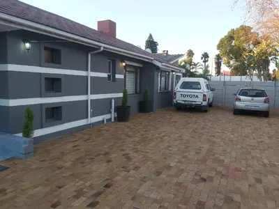 a house with two cars parked in a driveway at Hirondelle @ 45 Old Paarl in Bellville
