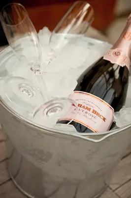 a bottle of wine in a bucket of ice at Avondrood Guest House by The Oyster Collection in Franschhoek