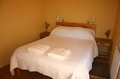 two towels on a bed in a room at Kierie Kwaak Self Catering in Stellenbosch