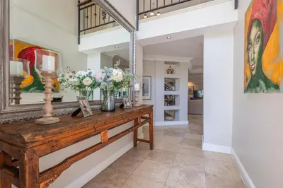 a hallway with a table with flowers on it at Maison du Cap in Cape Town