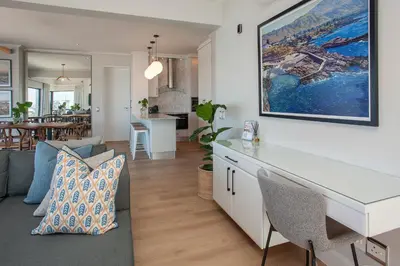 a kitchen and living room with a couch and a table at Hamewith Penthouse in Hermanus