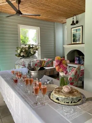a table with wine glasses and a cake on it at Hedge House Guest House in Cape Town
