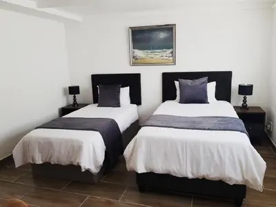 two beds in a room with at Arcangeli Wines in Botrivier