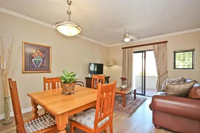 a dining room with a table and a couch at Vilaroux in Stellenbosch