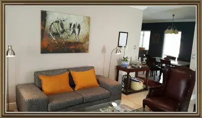 a living room with a couch and two chairs at 5 Pierre Jourdan in Franschhoek