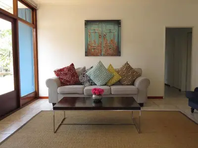 a living room with a couch and a coffee table at Villa V in Cape Town