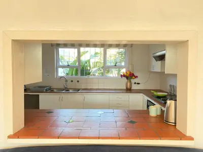 a kitchen with a tile floor and a sink at Villa V in Cape Town