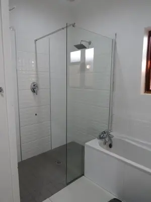 a bathroom with a shower with a glass door at Villa V in Cape Town