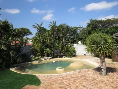 a small pool in a yard with trees at Villa V in Cape Town