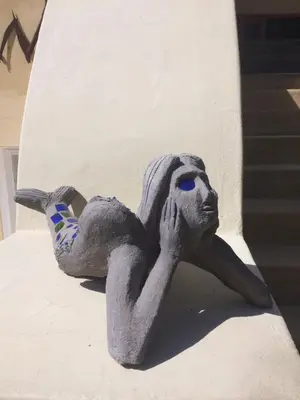 a statue of a person laying on the side of a wall at Olive Tree Garden apartment 1 in Cape Town