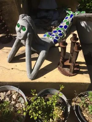 a statue of aitatingitatingitatingitatingitatingitatingitatingitatingitatingitatingitatingfficient at Olive Tree Garden apartment 1 in Cape Town