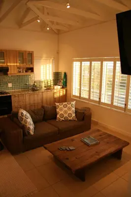 a living room with a couch and a coffee table at Freshhh in Bloubergstrand