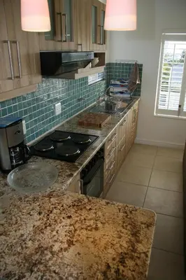 a kitchen with a counter top and a stove top oven at Freshhh in Bloubergstrand