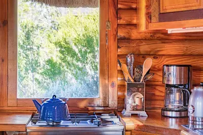 a stove top in a kitchen with a window at Tulbagh Mountain Cabin in Wolseley