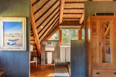 a large room with a wooden ceiling and a window at Tulbagh Mountain Cabin in Wolseley