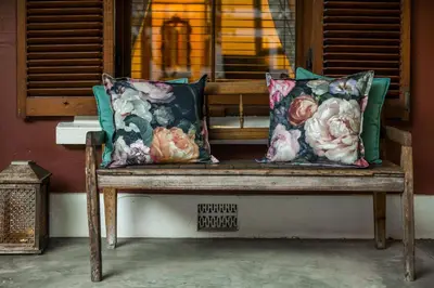 a wooden bench with two pillows on it at Roosenwijn Guesthouse in Stellenbosch