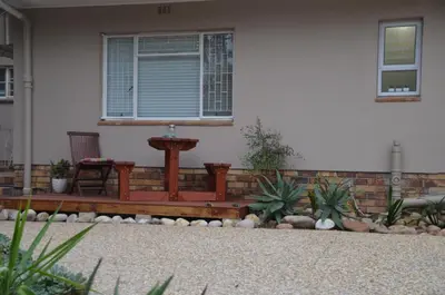 a porch with a bench in front of a house at Anni Bos in Stellenbosch