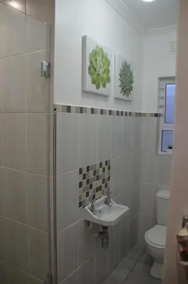 a bathroom with a sink and a toilet at Anni Bos in Stellenbosch