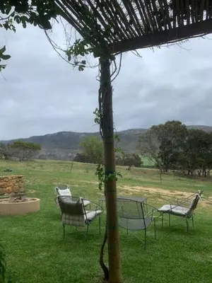 a group of chairs sitting in the grass at Shabach Farm in Hartebeest Rivier