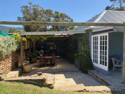 an outdoor patio with a table and chairs at Shabach Farm in Hartebeest Rivier