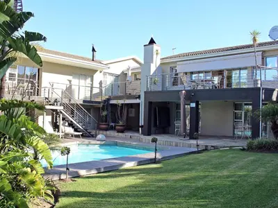 a house with a swimming pool in a yard at Eversview Guesthouse in Durbanville
