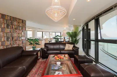 a living room with leather furniture and a chandelier at Ocean View 505 Self Catering Accommodation Strand Western Cape South Africa in Strand