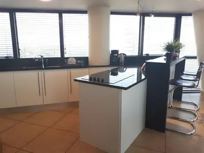 an office with a counter and some chairs and windows at Ocean View 905 Self Catering Accommodation Strand Western Cape South Africa in Strand
