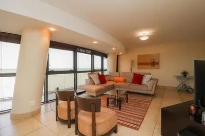 a living room with a couch and a table at Ocean View 905 Self Catering Accommodation Strand Western Cape South Africa in Strand