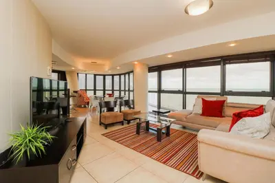 a living room with a couch and a table at Ocean View 905 Self Catering Accommodation Strand Western Cape South Africa in Strand