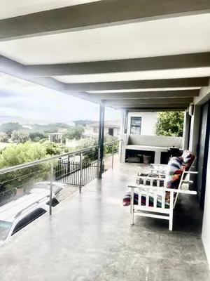 a balcony with a couch and a table on a balcony at 3 Indigo with Solar in Hermanus