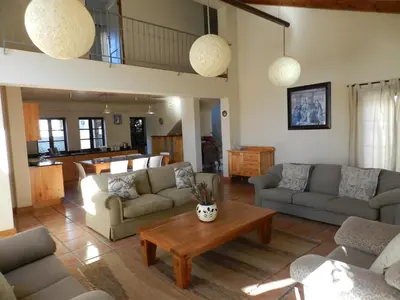 a living room with couches and a coffee table at Sunset at Diluta in Cape Town