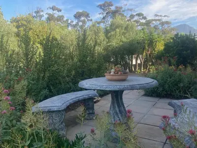 a stone table with a bowl on top of it at Suikerbekkie in Somerset West