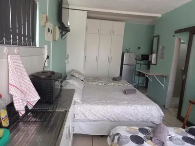 a room with two beds in a kitchen with a stove at Mountainia Inn in Worcester